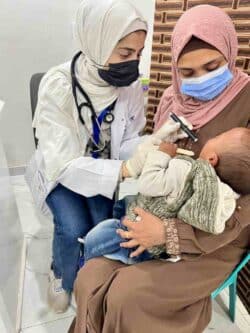 Woman doctor check on newborn in Gaza