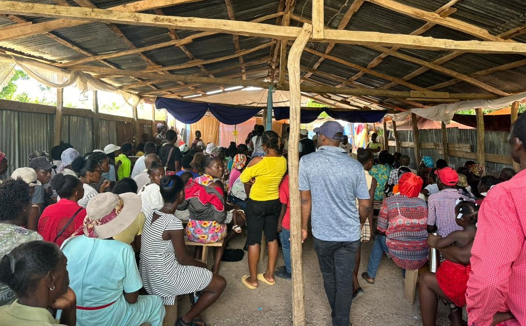 A group of Haitians sitting in a pavilion