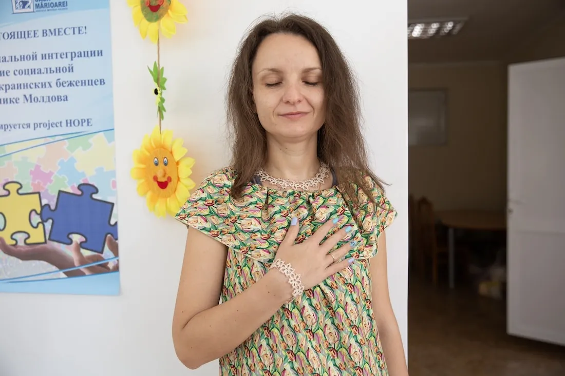 woman holding hand over heart