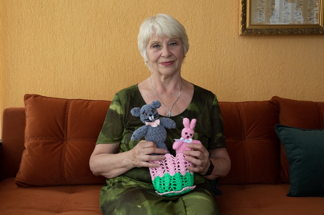 elderly woman with knitted animals