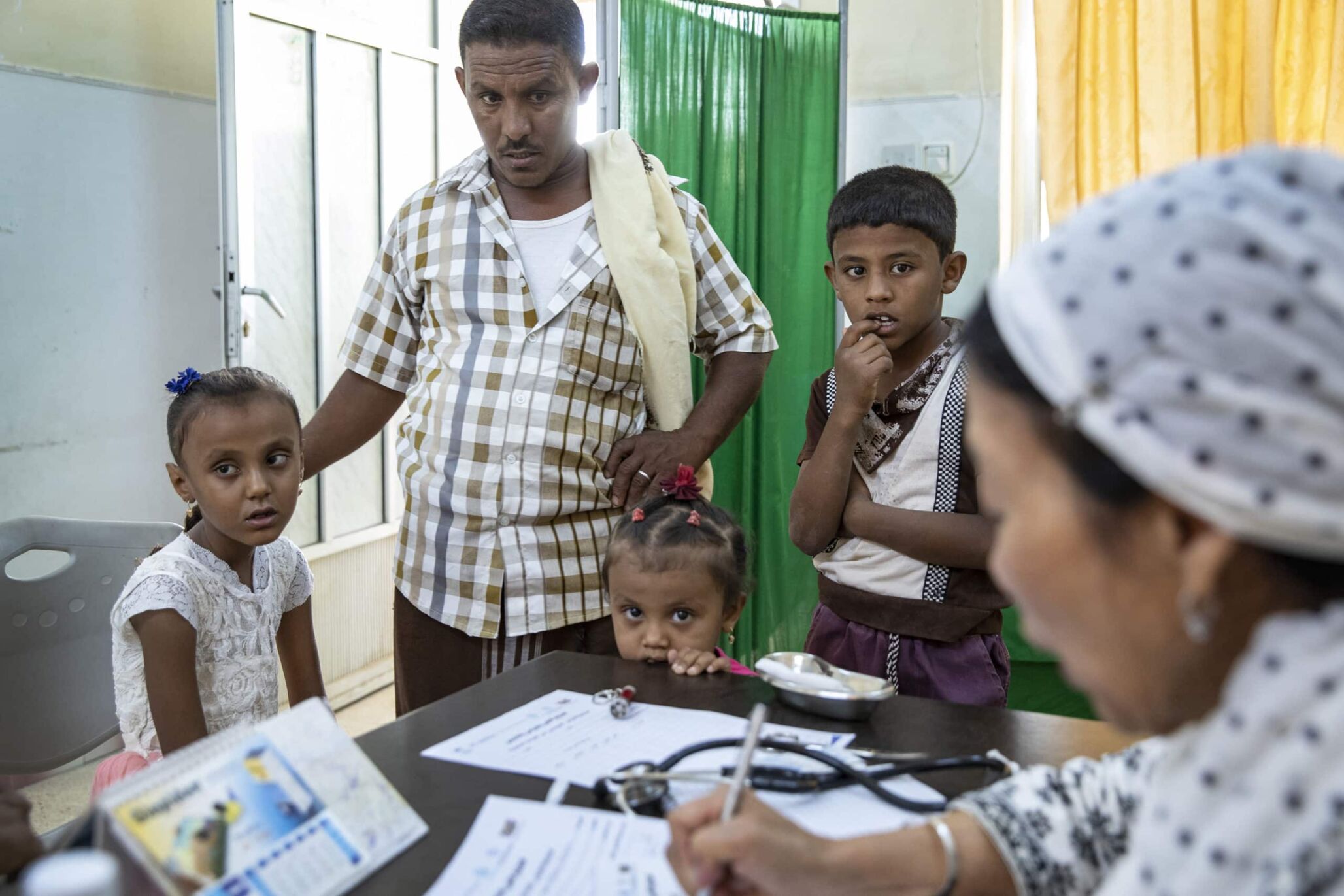 Yemeni family receiving humanitarian assistance.