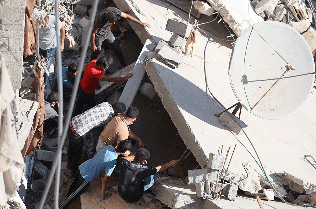 people digging through rubble