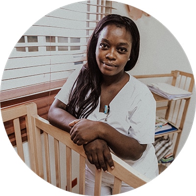 Photo of nurse leaning on a crib