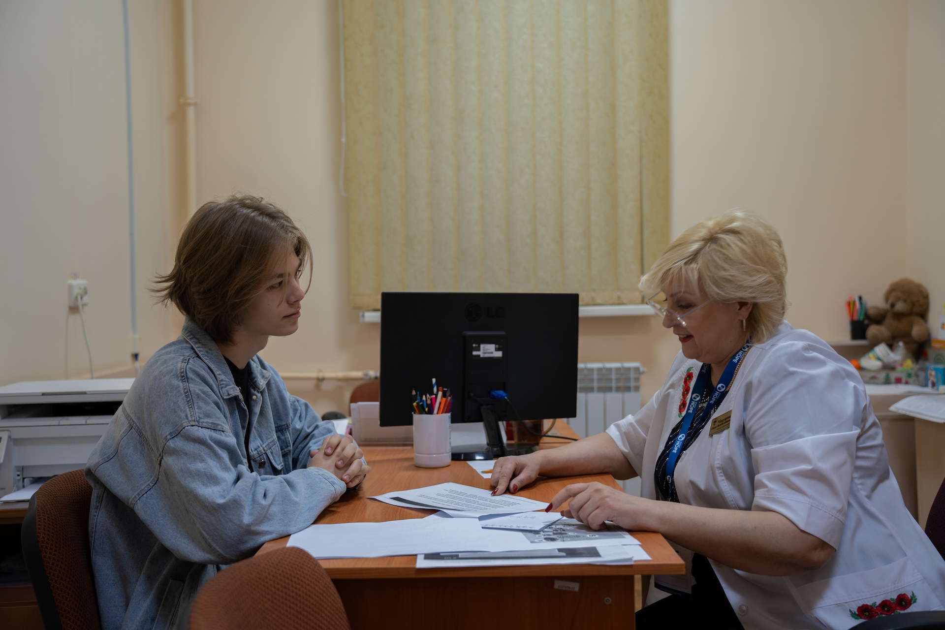 Psychologist speaking with young teen in Ukraine