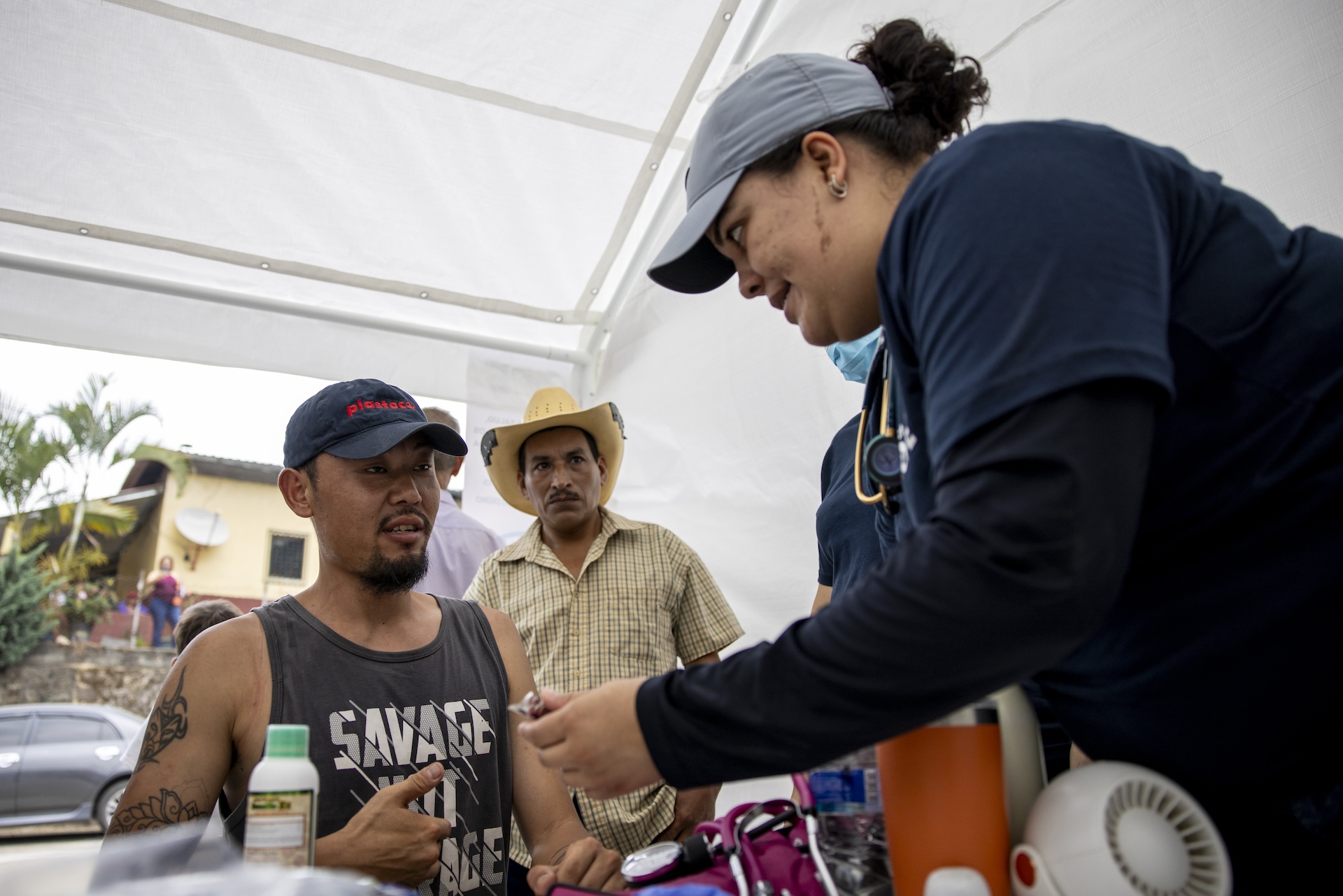 medical doctor checks on patient in Honduras