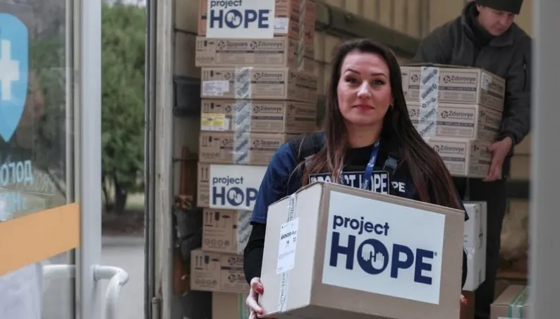 woman holding Project HOPE box