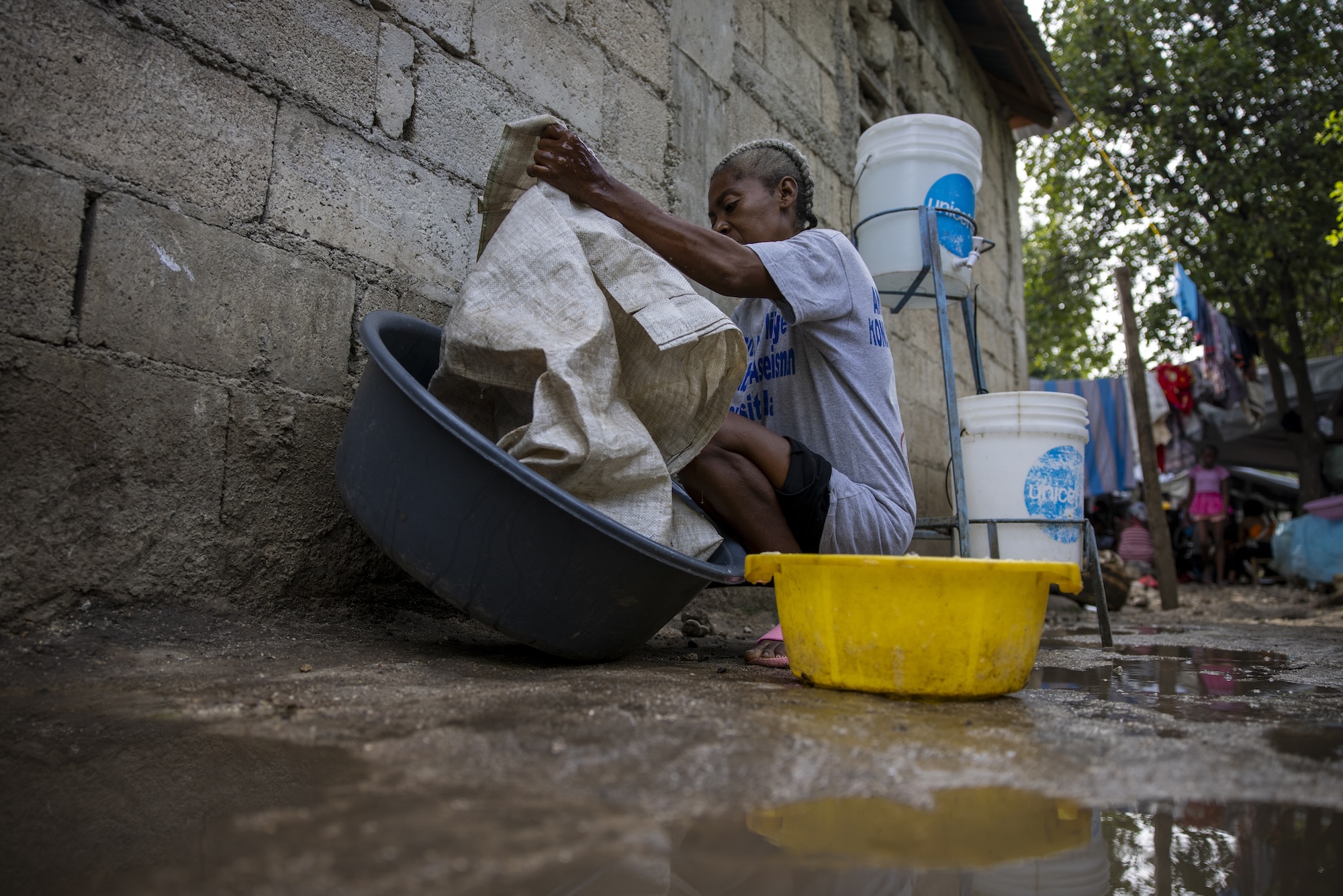 woman cleaning clothes in Haiti