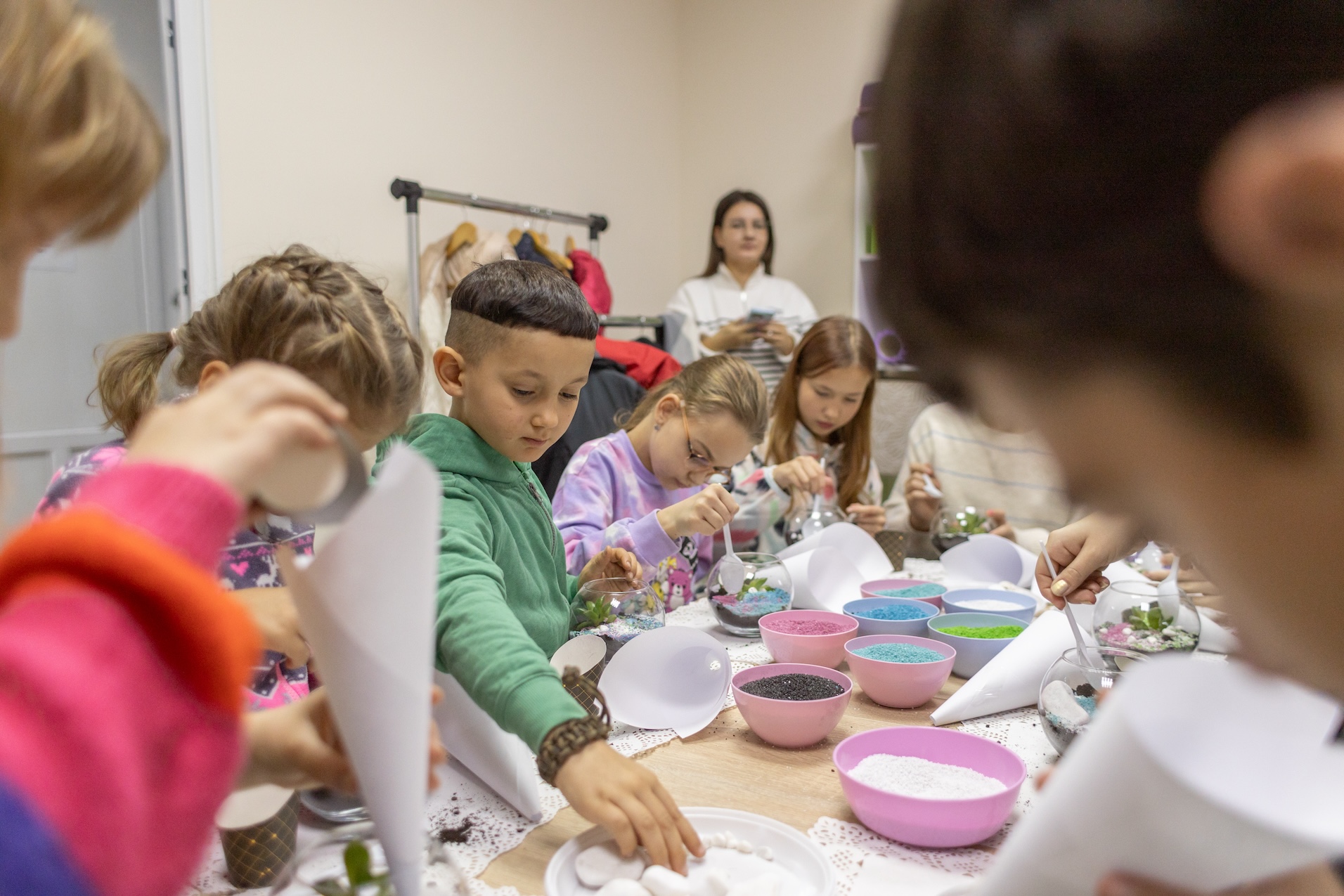 A group of young children playing with sand art