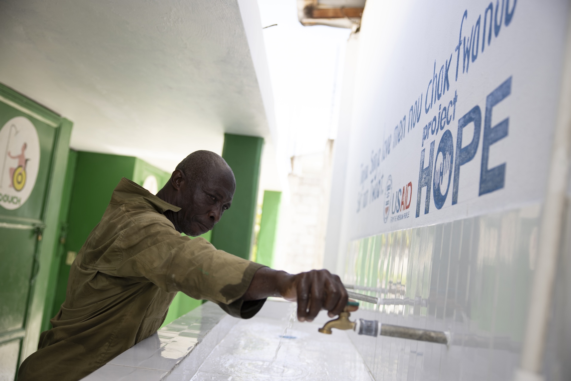 A man using water spouts in Haiti