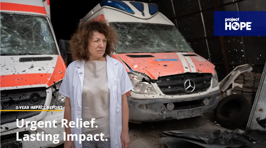 woman standing in front of ambulances with text on image that say Urgent Relief. Lasting Impact.