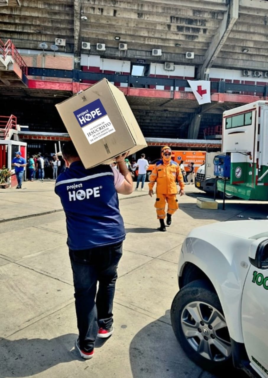 man carries box into hospital